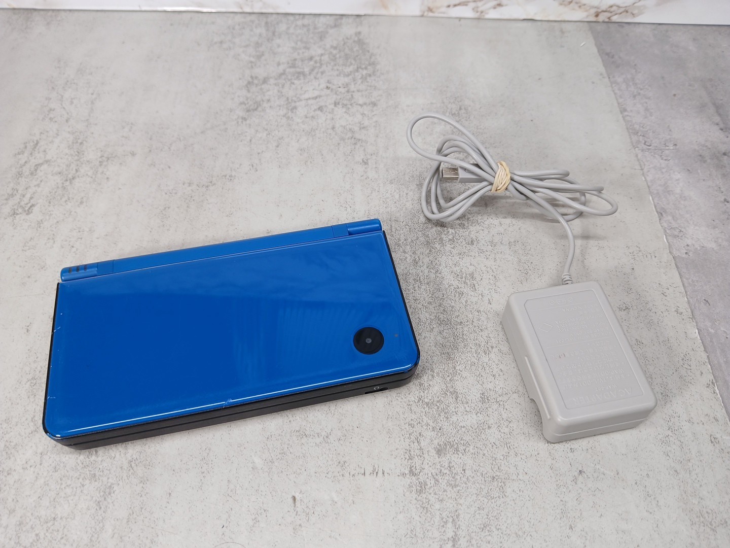 Nintendo DSi XL Blue Handheld Gaming Console- No Stylus. Charger is Non-OEM