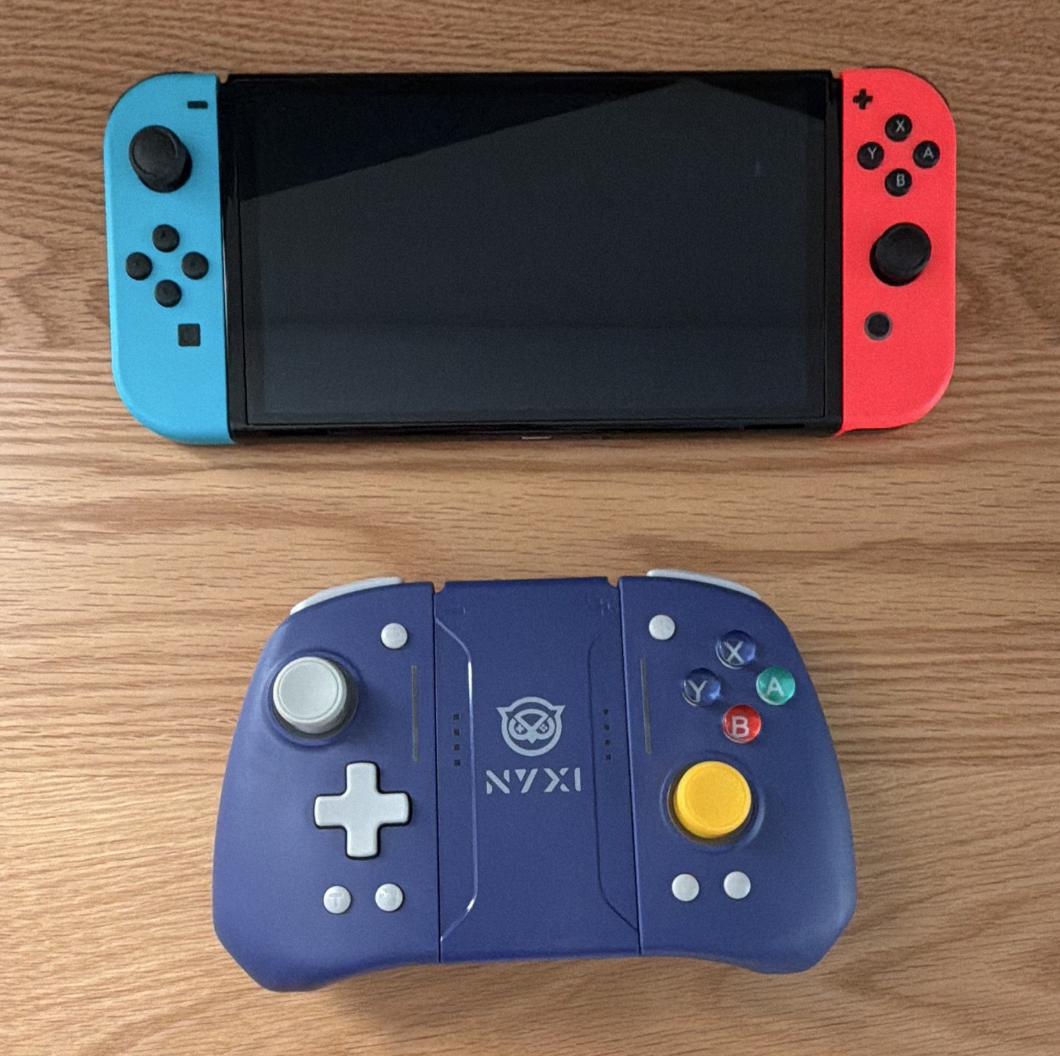Nintendo Switch V2 OLED Console w/ Red/Blue Joy-Con + NYXI Purple Controller