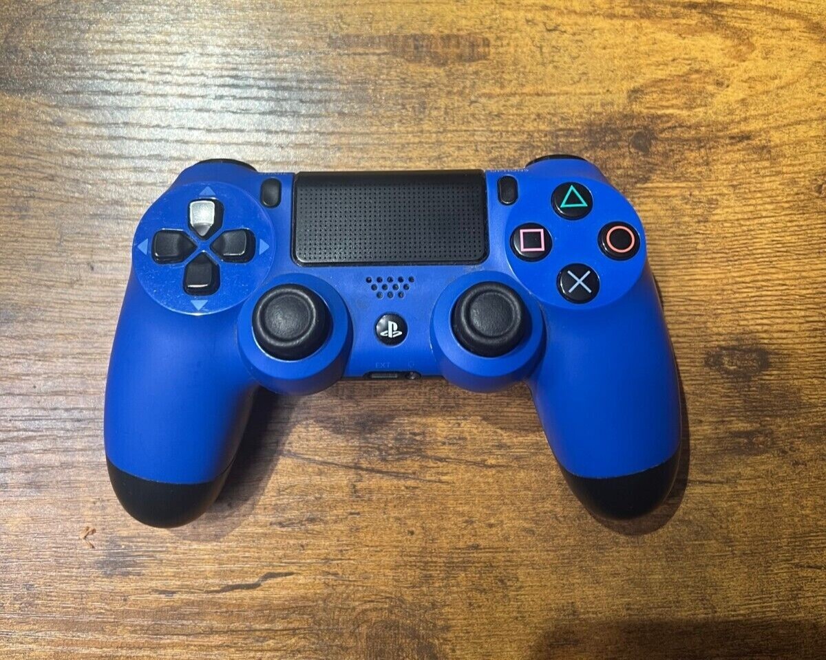 PlayStation 4 (Used) with 3 Controllers (red, white, and blue) and 9 PS4 Games