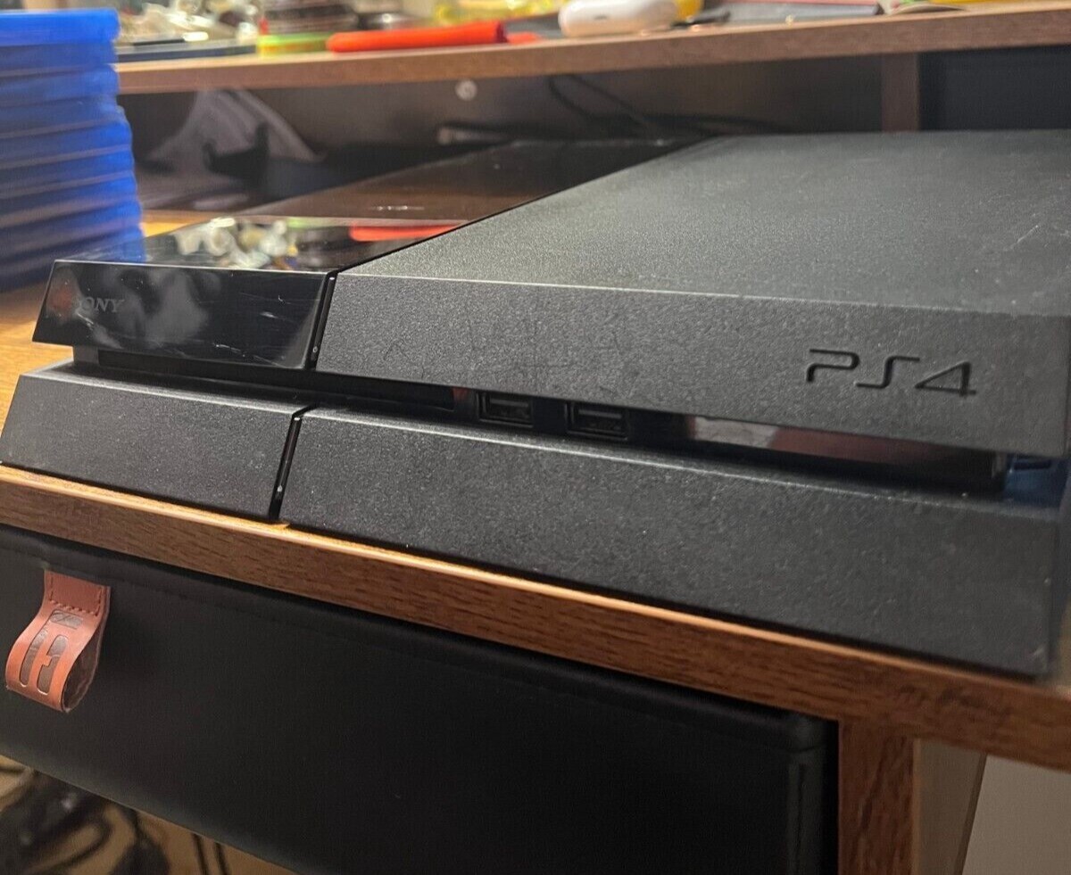 PlayStation 4 (Used) with 3 Controllers (red, white, and blue) and 9 PS4 Games