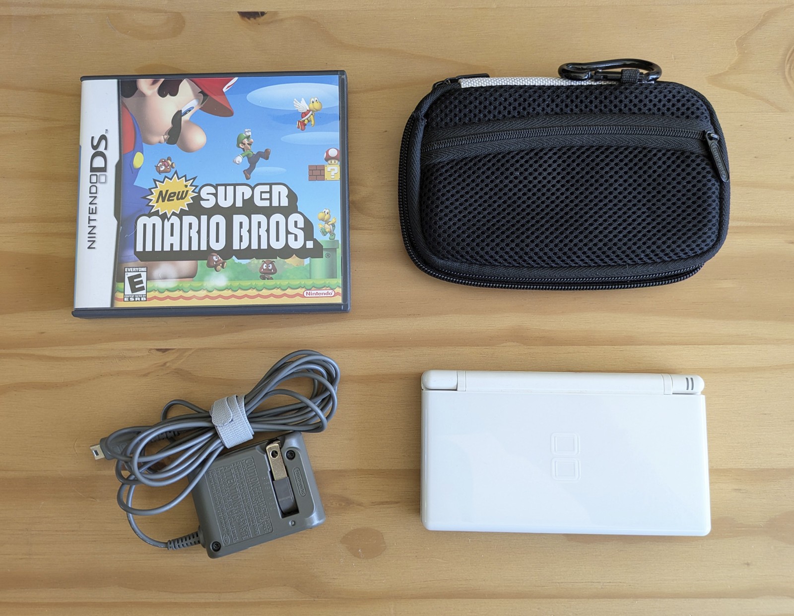 Nintendo DS Lite White + Carrying Case + OEM AC Adaptor + New Super Mario Bros.