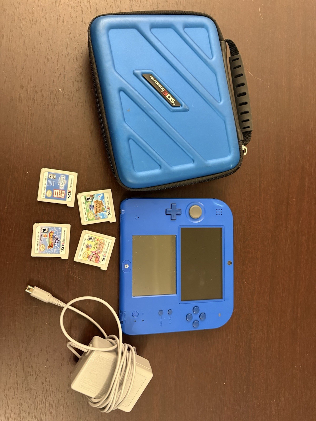 Nintendo 2DS Handheld System With charging Cord, Case, And Four Games