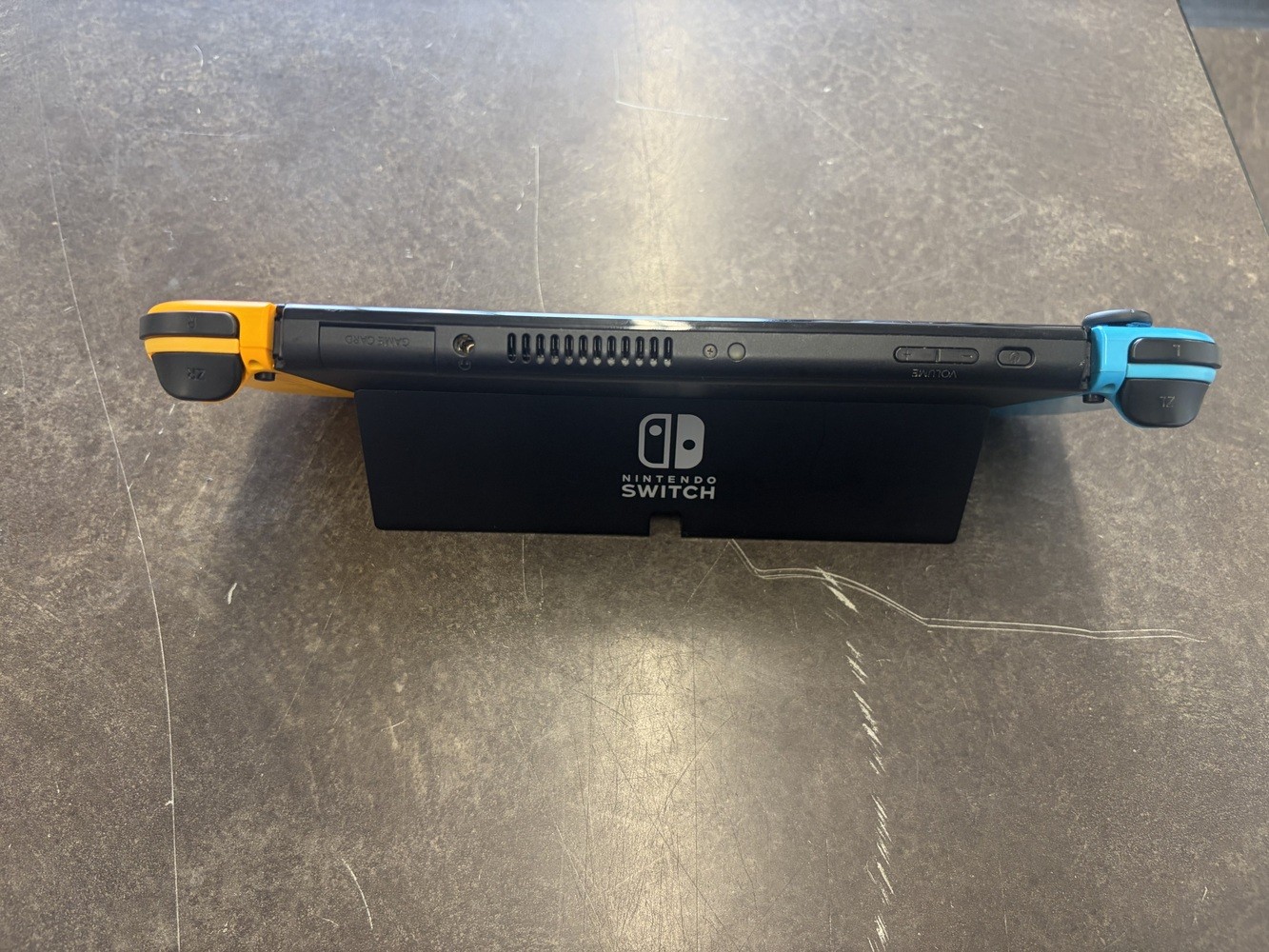NINTENDO SWITCH OLED MODEL W/ NEON BLUE & NEON ORANGE JOY CONS