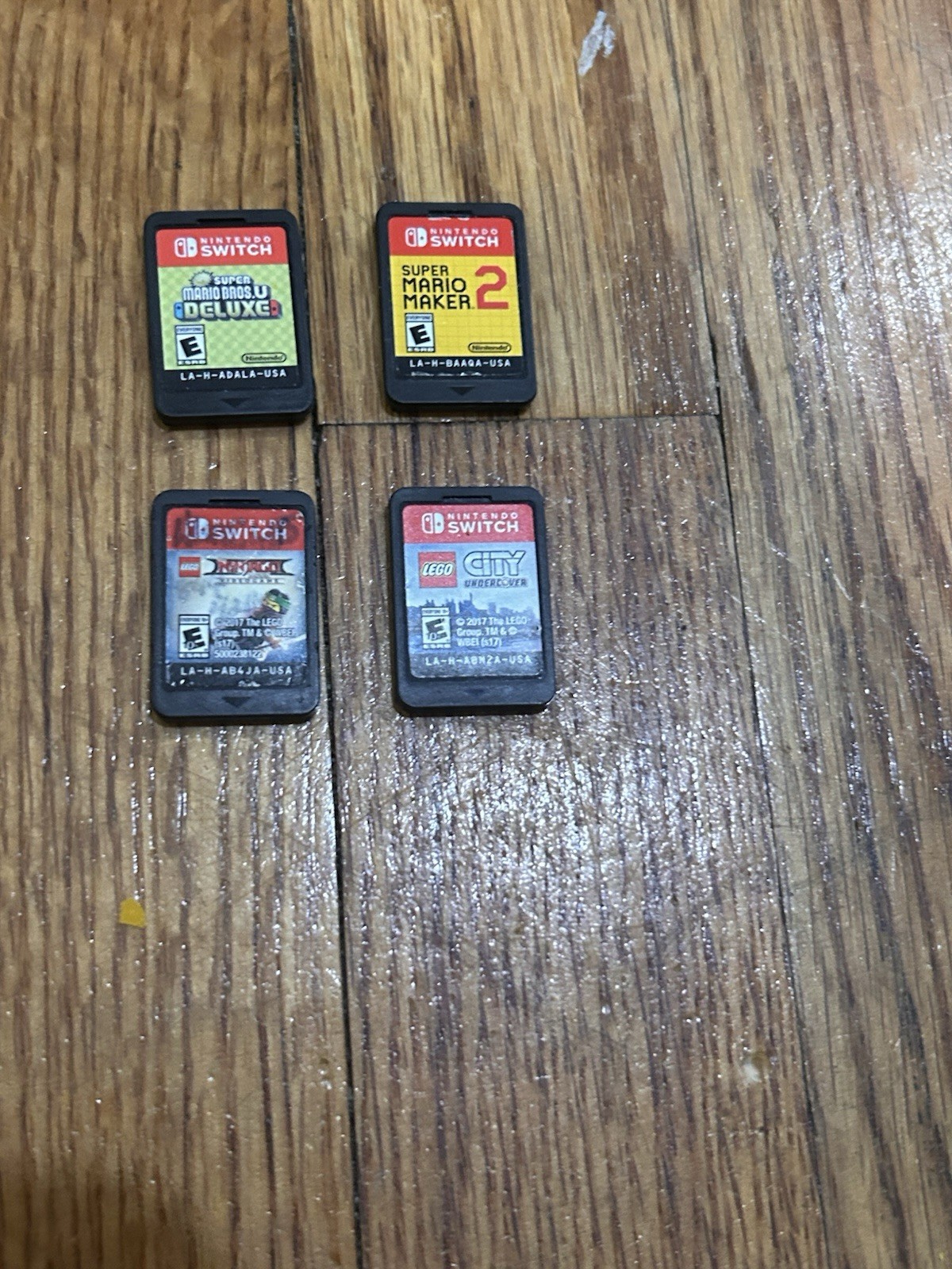 Nintendo Switch with joycon controllers, a charger, 4 games, and a game case.