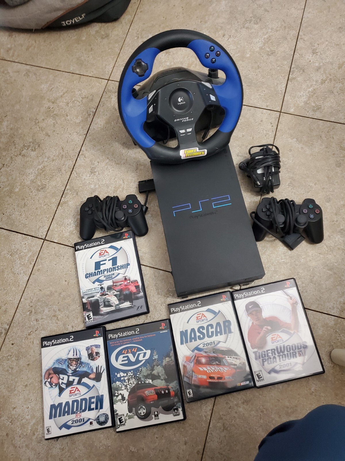 Sony PlayStation Black Console, With 2 Controllers, Wheel, Pedal and Games.