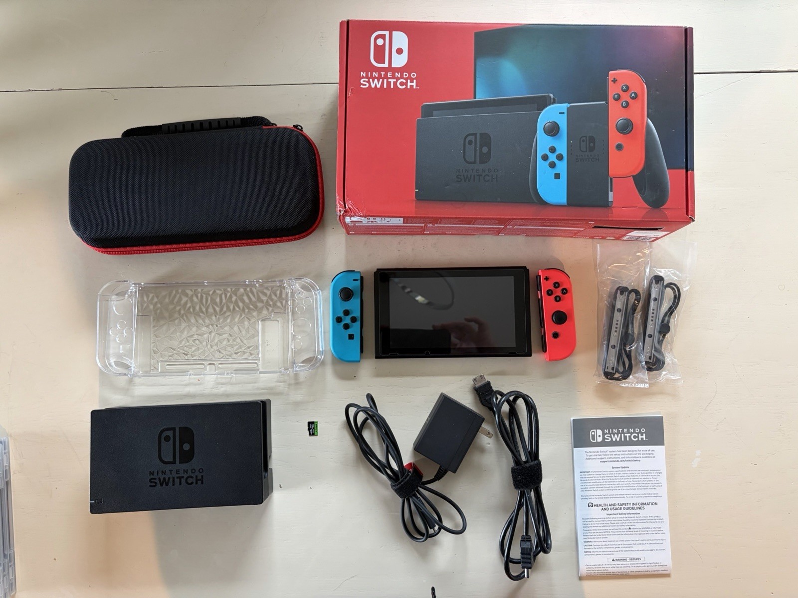 Nintendo Switch version 2, opened box, HAC-001(-01) handheld console, red/blue.