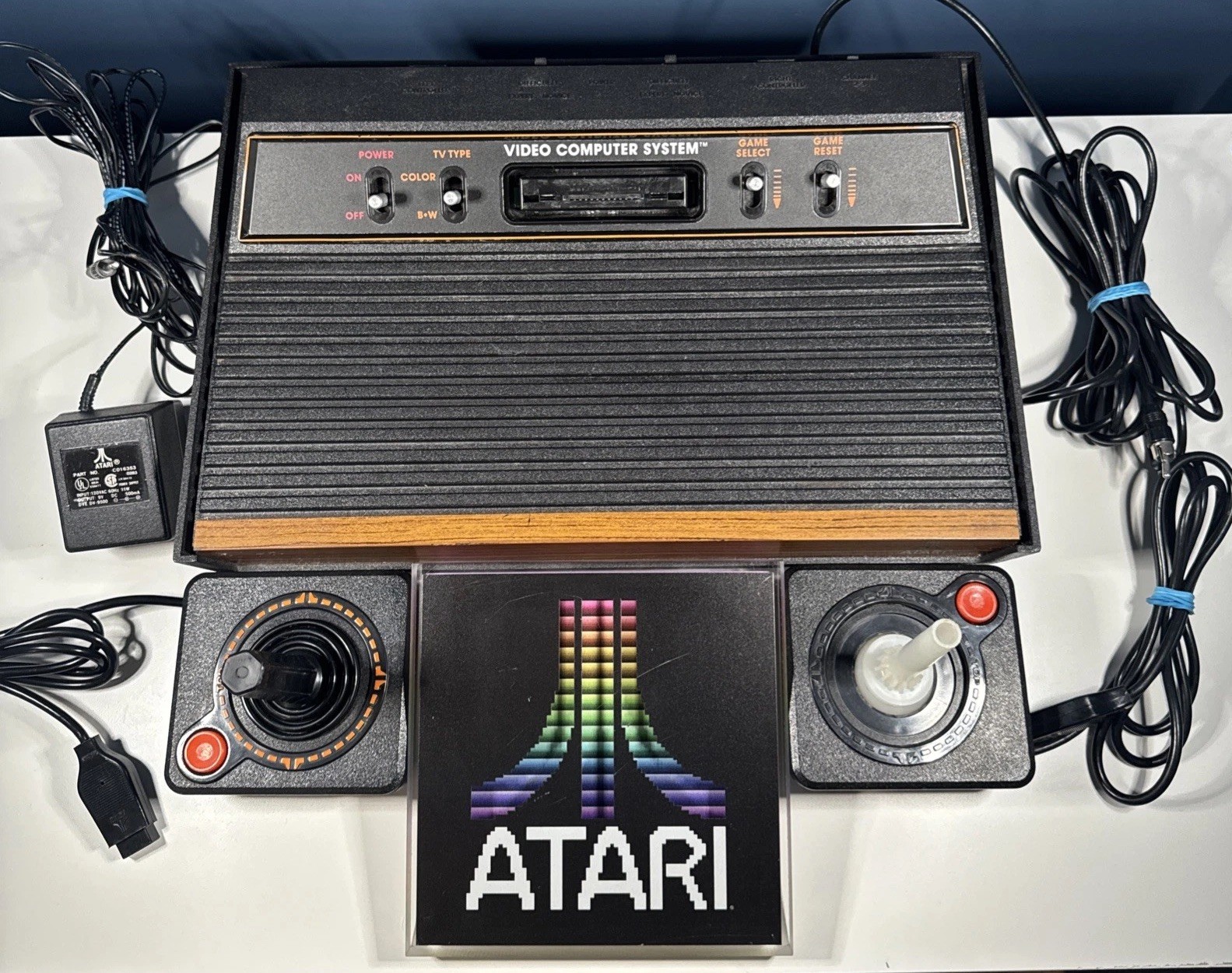 Atari 2600 Wood Grain 4 Switch Console + 2 Controllers UNTESTED w/Atari Desk Art