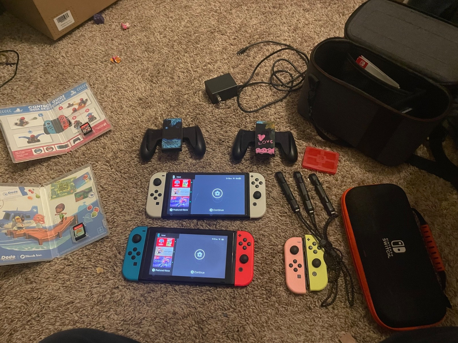 Nintendo Switch OLED console and regular Nintendo switch with accessories&games