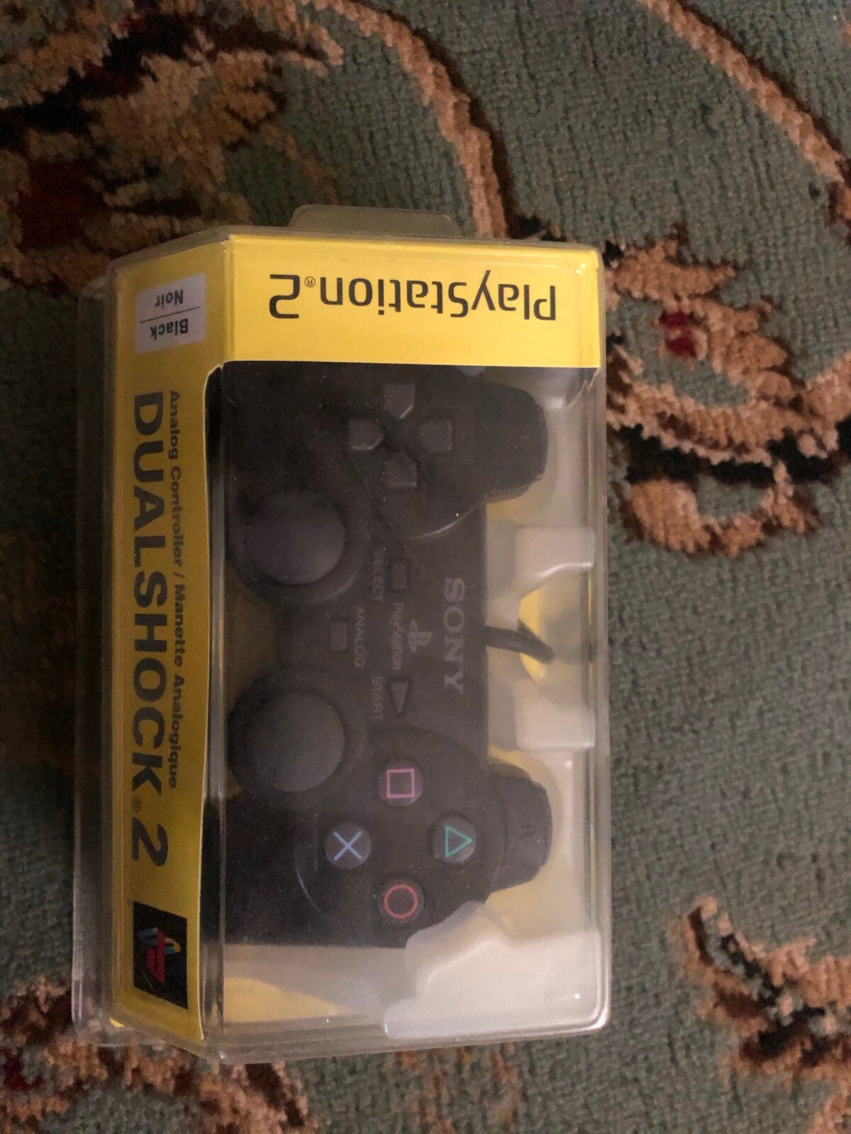 Black Sony PlayStation 2 lot with 2 controllers, 32 MB of memory, and 3 games.
