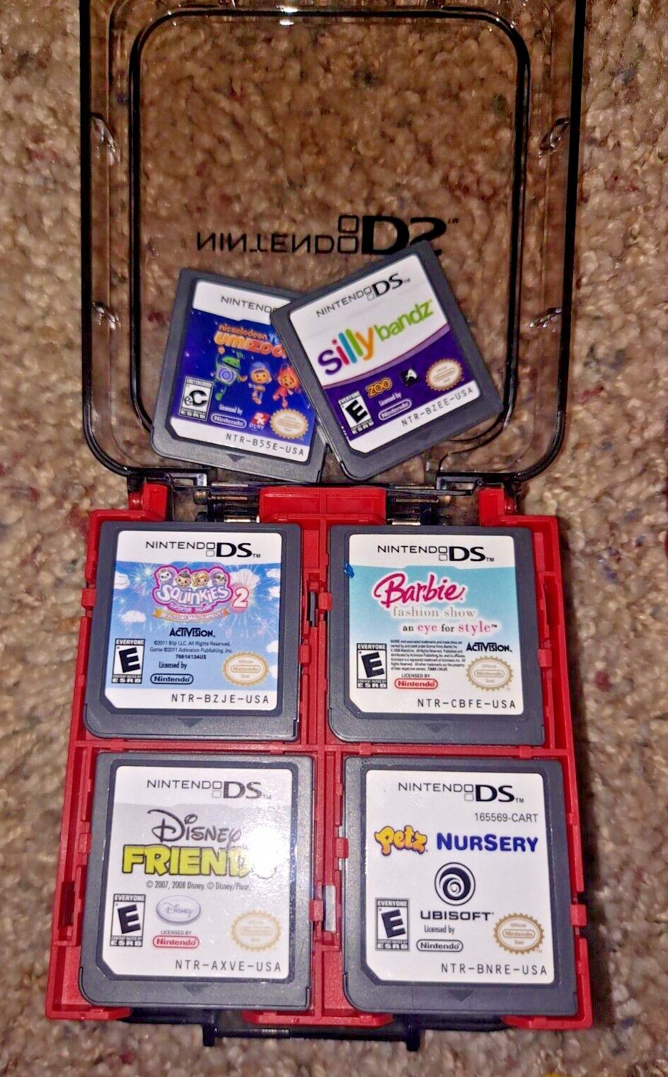 Nintendo DSi Red console system w 18 games in storage case w/ charger