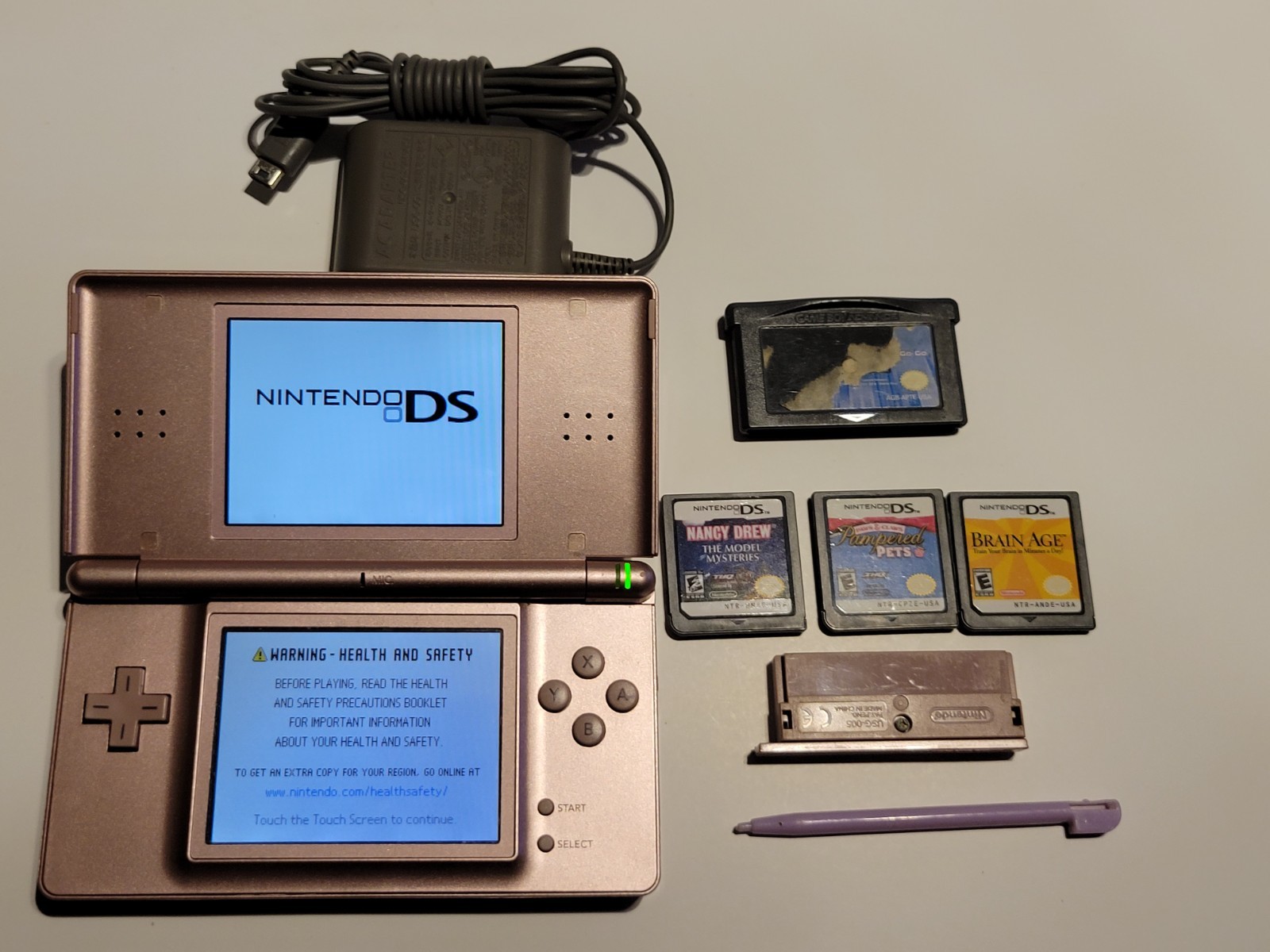 Nintendo DS Lite USG-001 Metallic Rose, 4 games + Pink Stylus + Original Charger