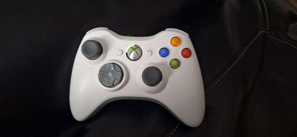 Black Microsoft Xbox 360 E Console With White Controller and AC Power Adapter