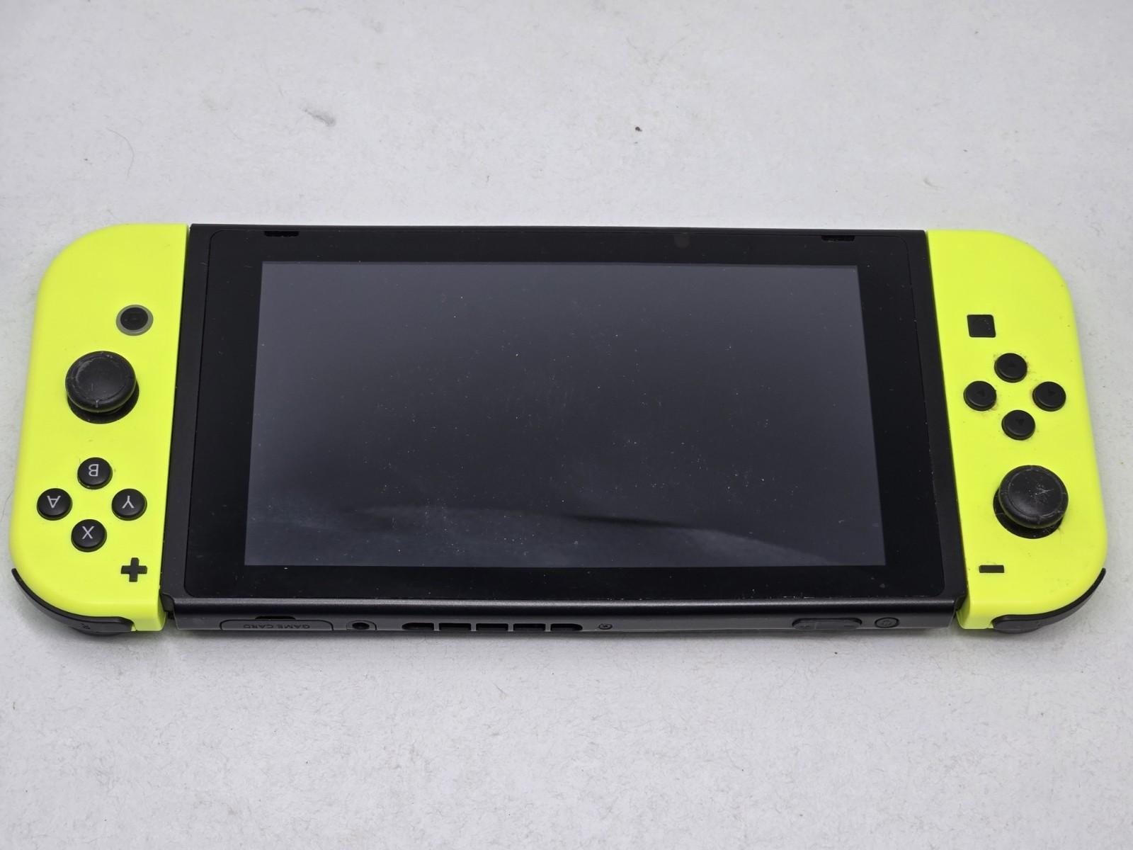 Vibrant Nintendo Switch console. Has black console with cool neon yellow…