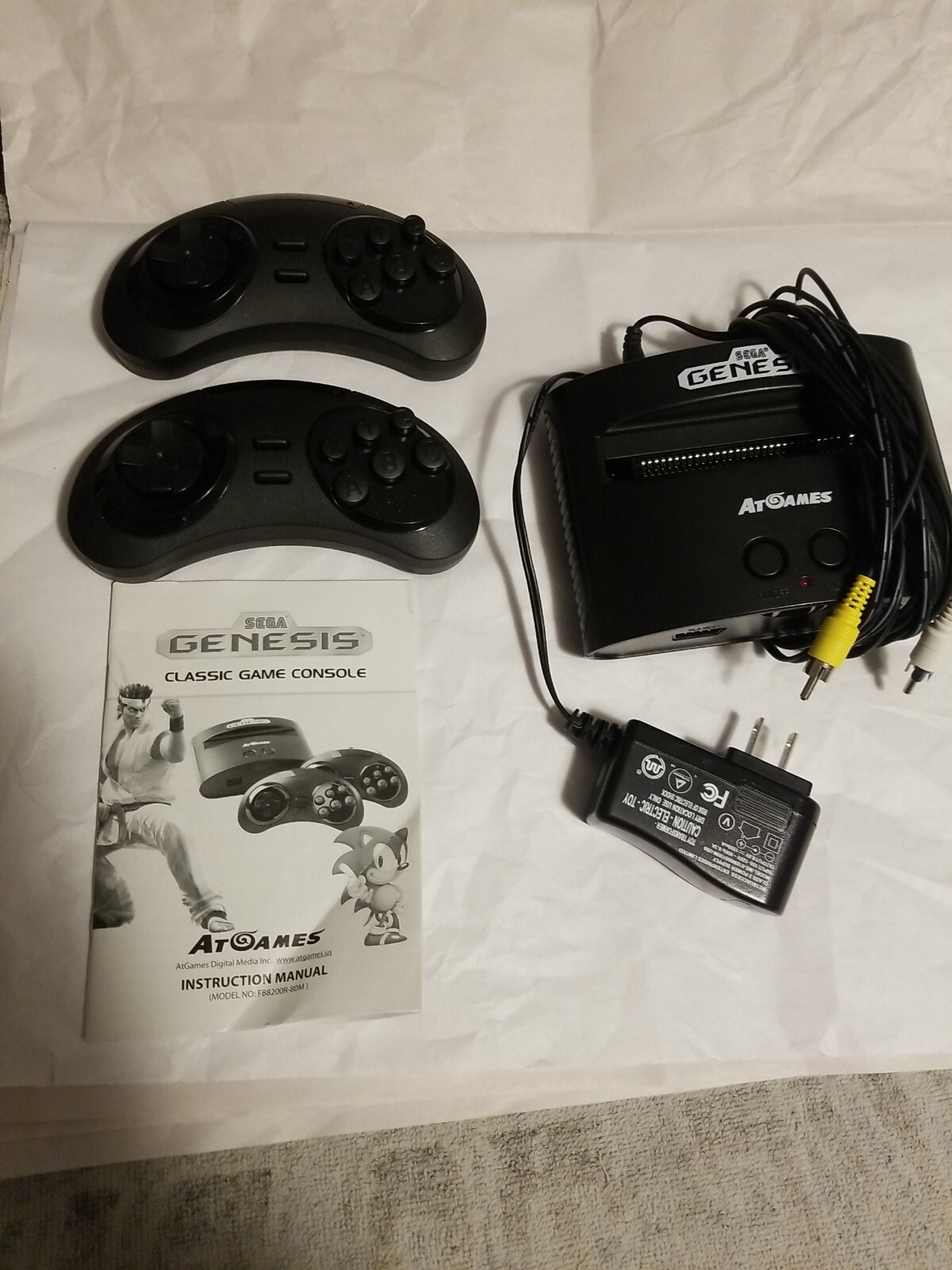 At Games Sega Genesis Classic Console With 2 controller and 40 games Built in.