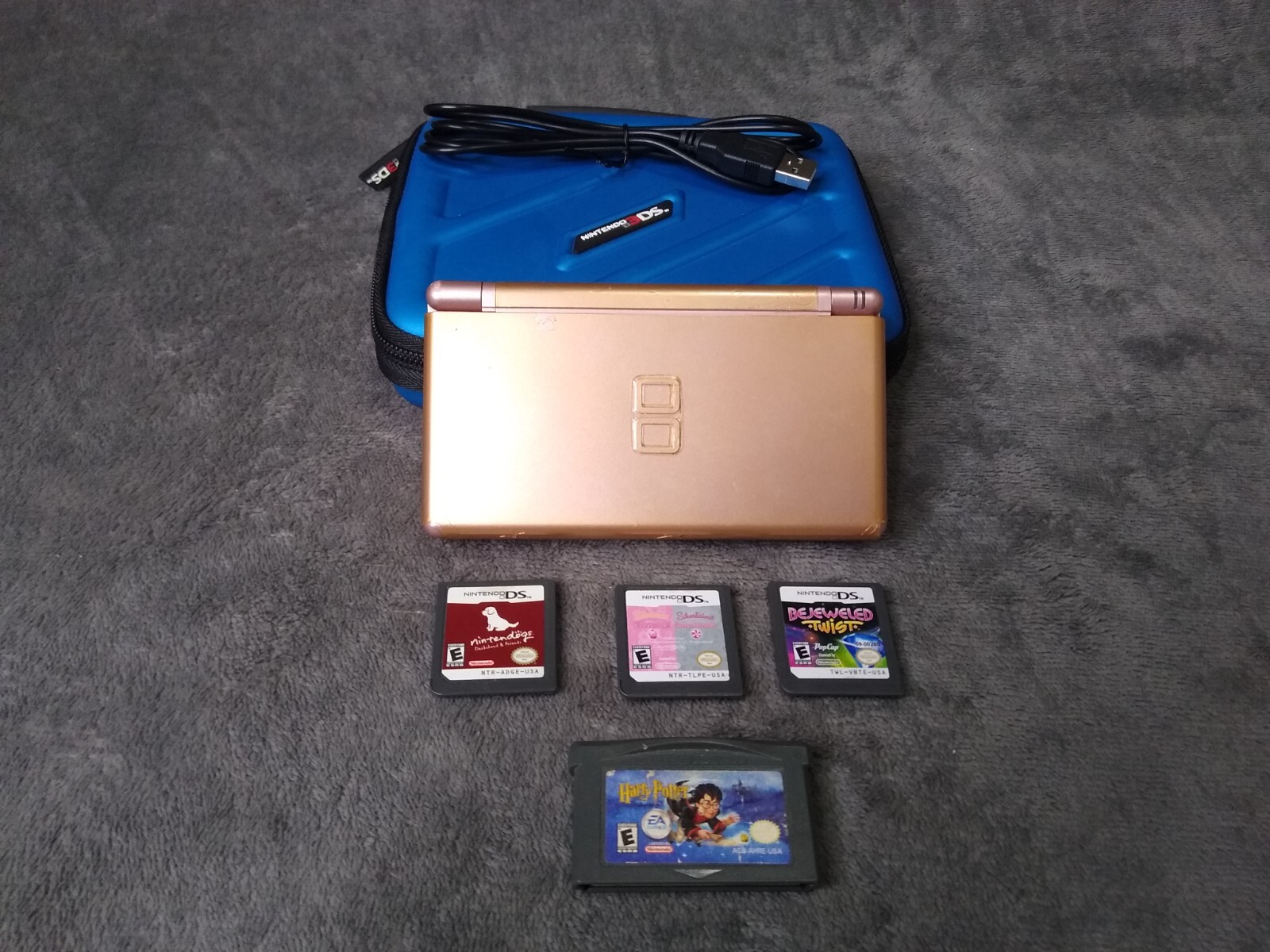 Nintendo DS Lite With 4 Games New Charging Cord . A Battery And A Carry Case