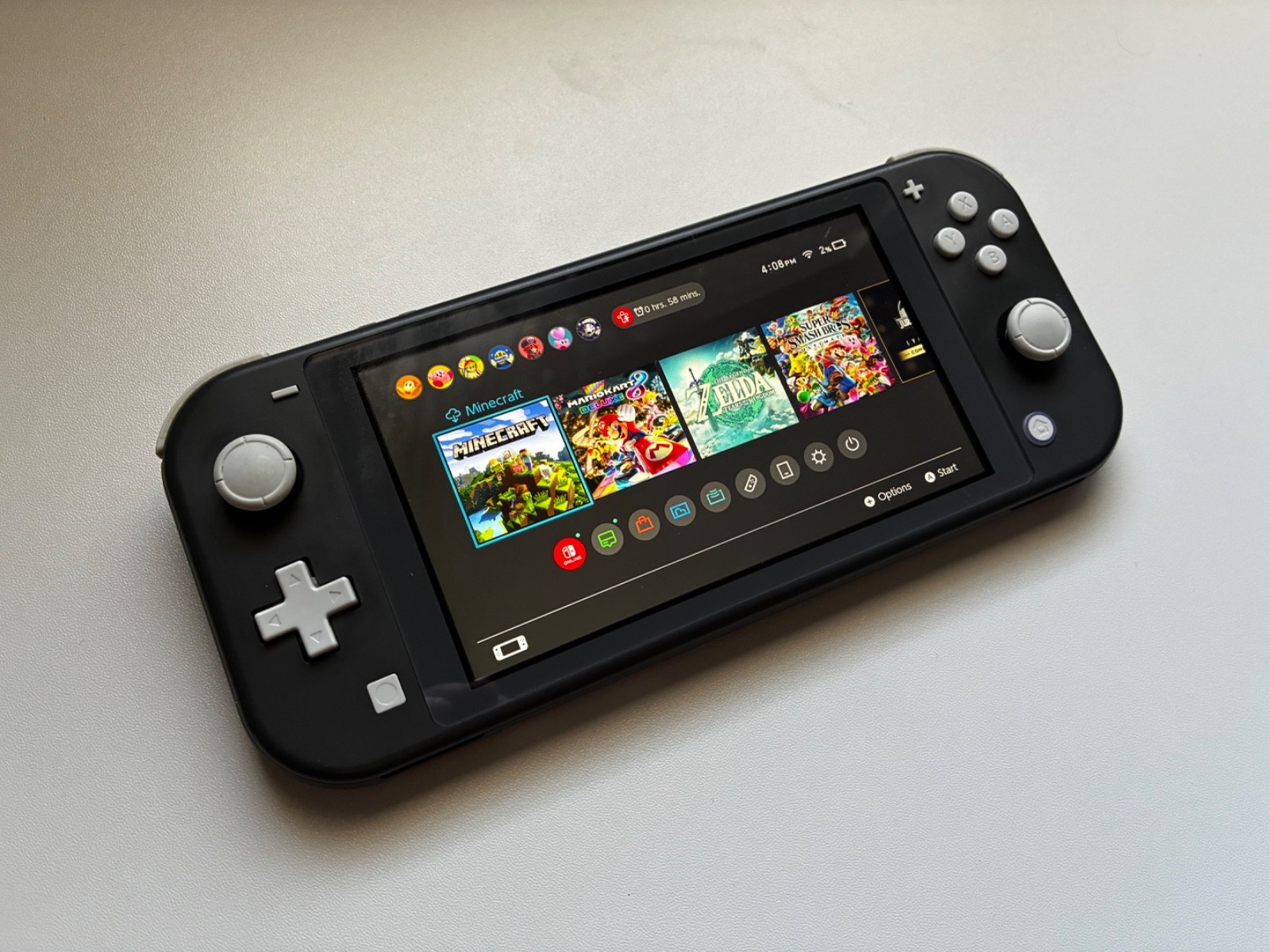 Nintendo Switch Lite Gray Handheld with Mario Kart cartridge