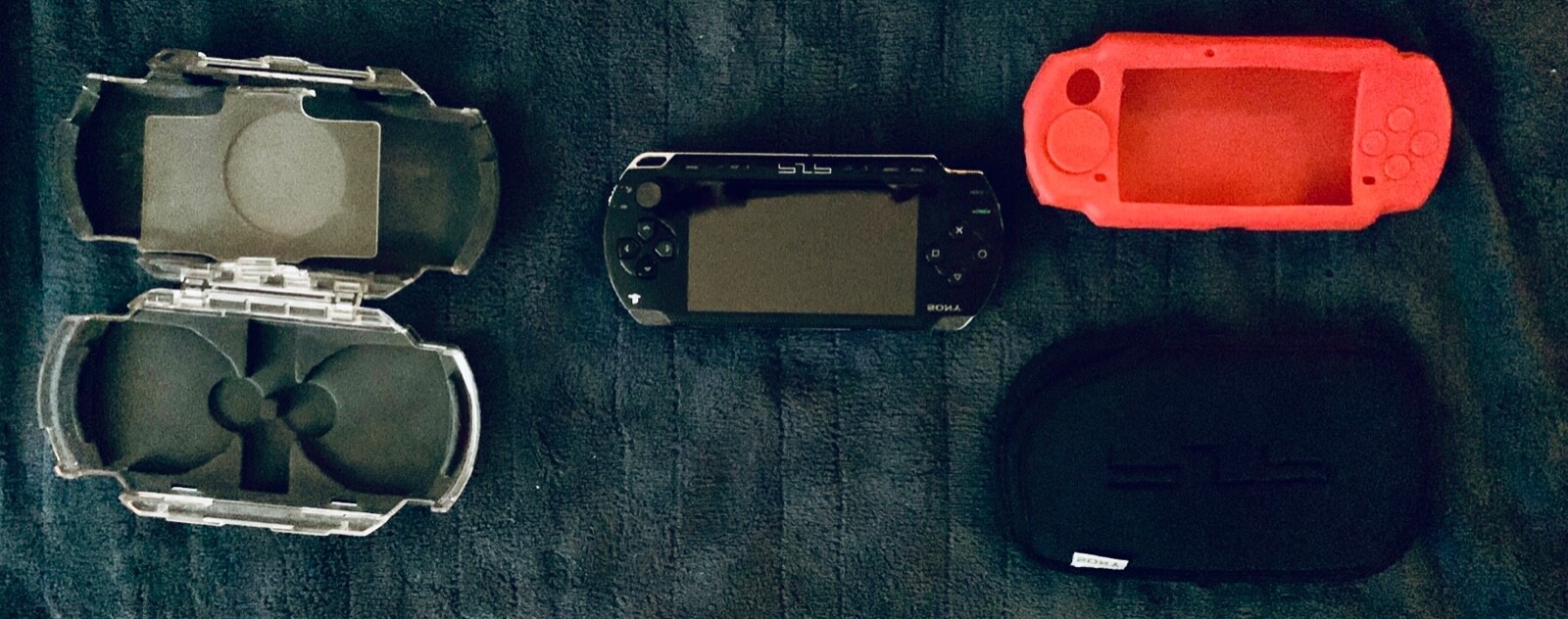 PSP Portable-Black-See through Hard case-Red silicone case-Black sleeve included