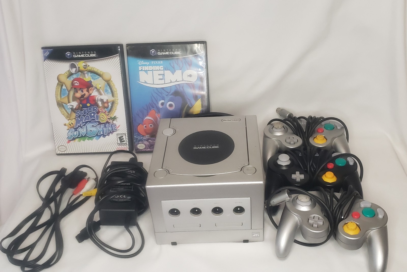 GameCube with 3 remotes, 2 games, cords, and remotes!