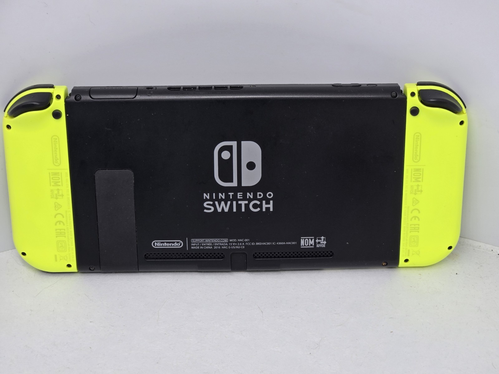 Vibrant Nintendo Switch console. Has black console with cool neon yellow…