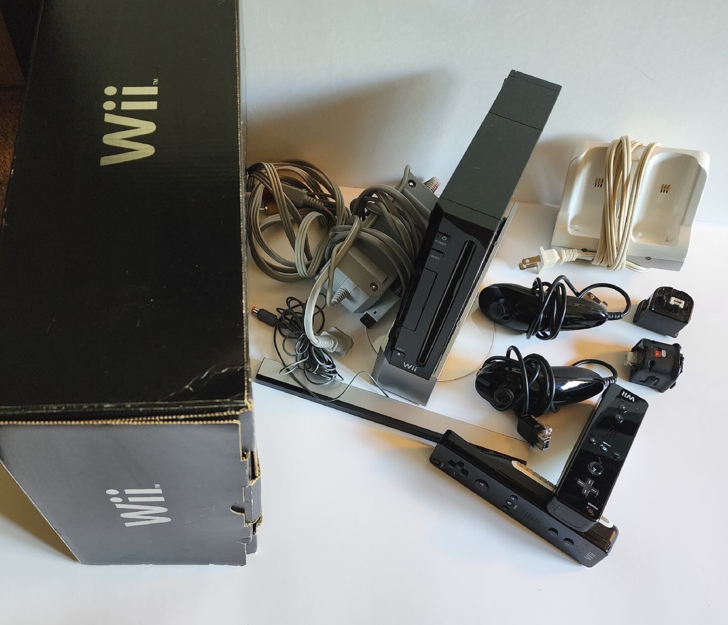 Nintendo Wii Black, 2 Wii Remote Plus, Charger Base With Assorted Games As Seen