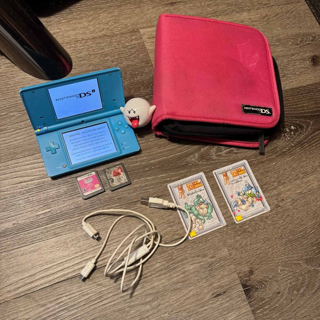 Nintendo DSi Handheld Console Blue With Pink Case and Games Bundle