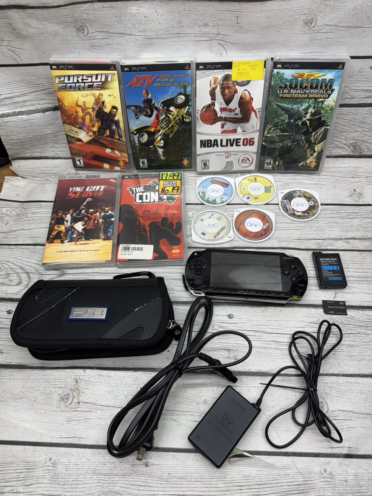 Sony PSP-1001 Black Console With Charger, 1GB Sony Storage Memory Card, 5 Games