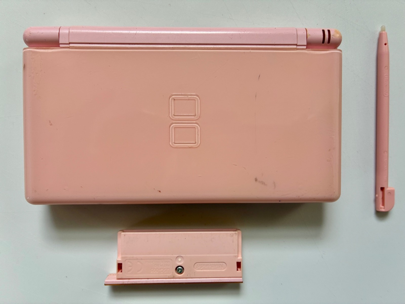 Nintendo DS Lite Handheld Console with Stylus and GBA Cover. Works, Cracks- Pink