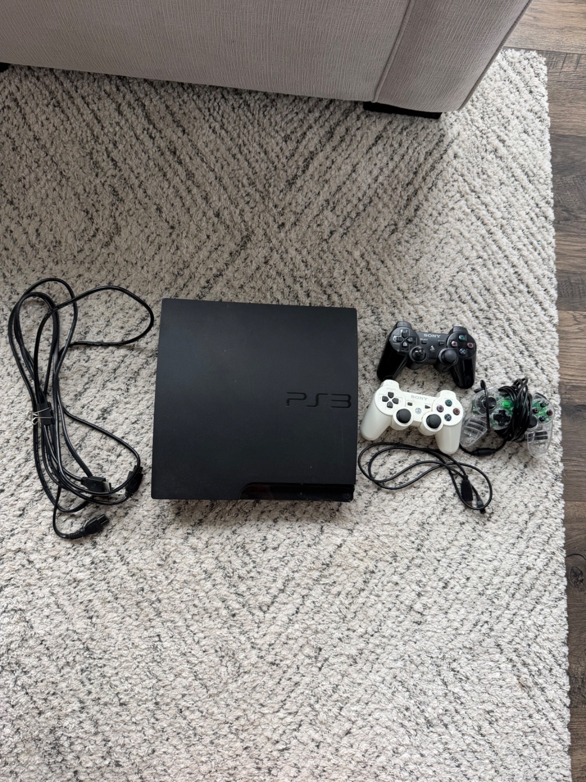 PlayStation 3 Slim Uncharted 3 160GB Charcoal Black Console with controllers
