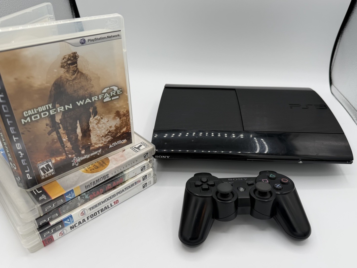 Sony PS3 Super Slim 120GB SSD Refurbished Bundle – OEM Controller & 5 Games