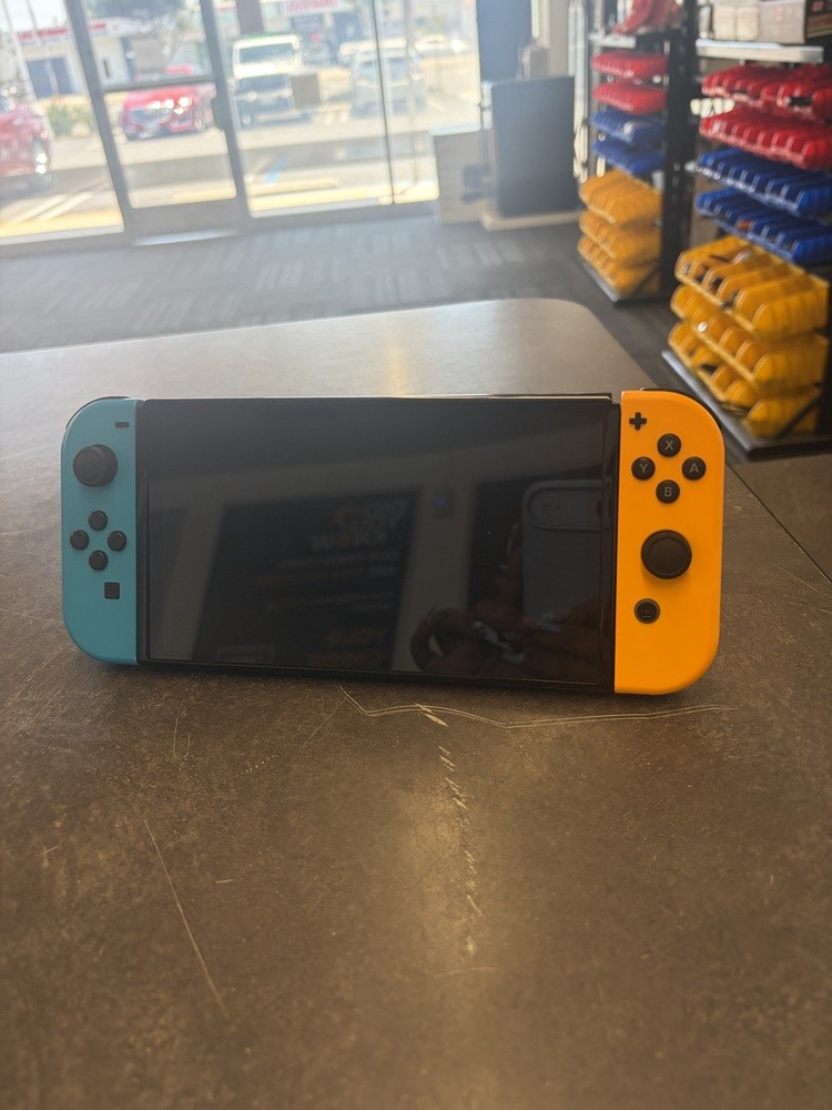 NINTENDO SWITCH OLED MODEL W/ NEON BLUE & NEON ORANGE JOY CONS