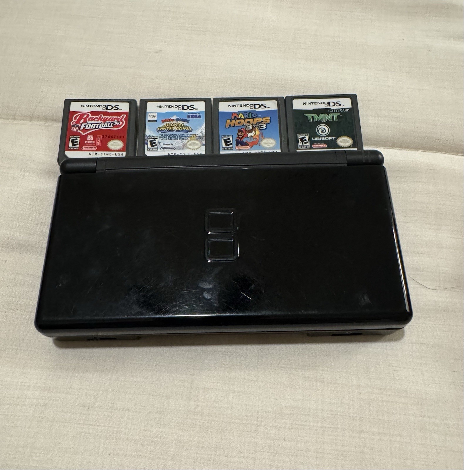 Pre-Owned Working Black Nintendo DS W Four Games And Charger With Minor Smudges