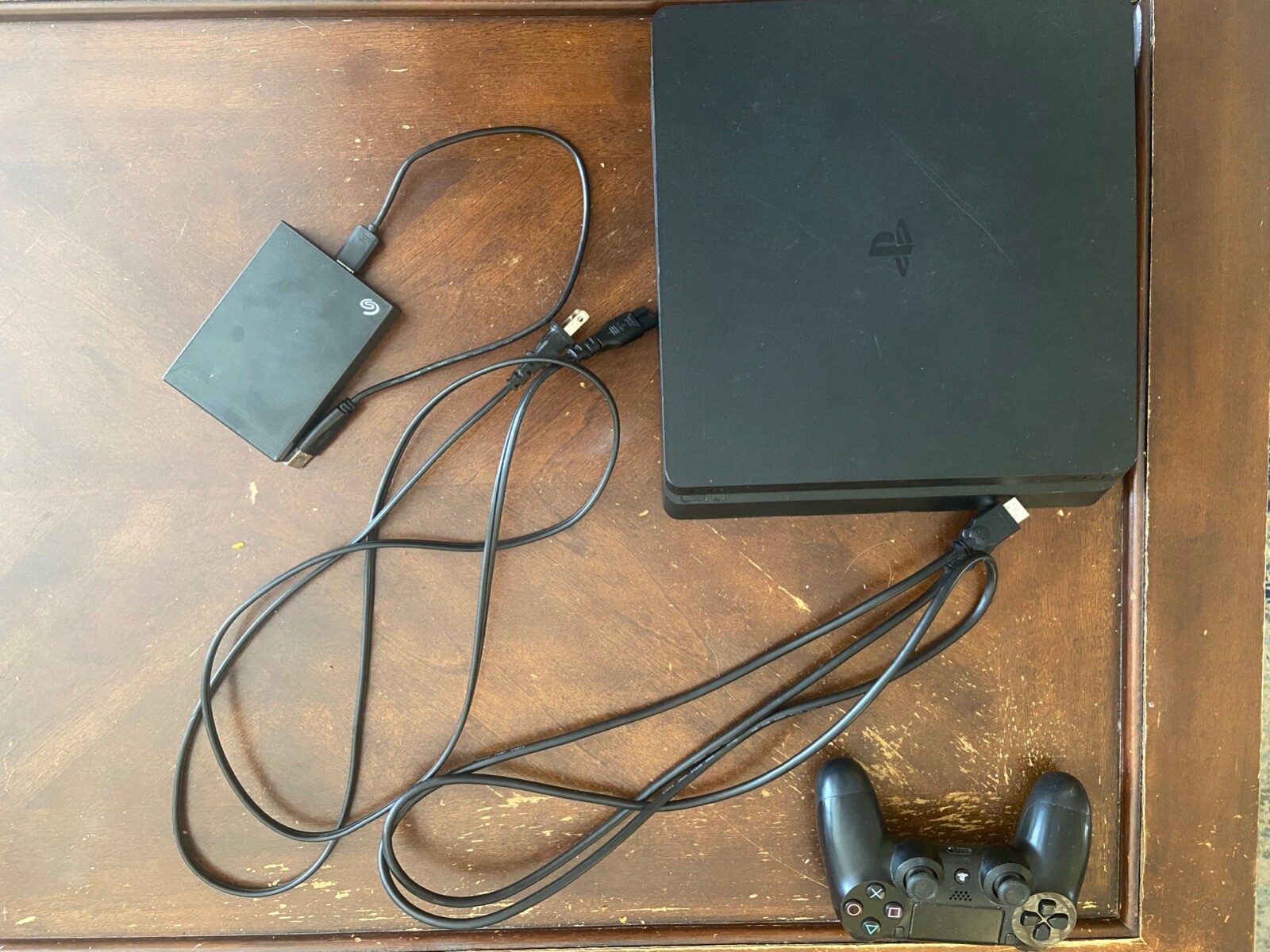sony ps4 slim 500gb console with controller, 4tb external hard drive, and 4 game