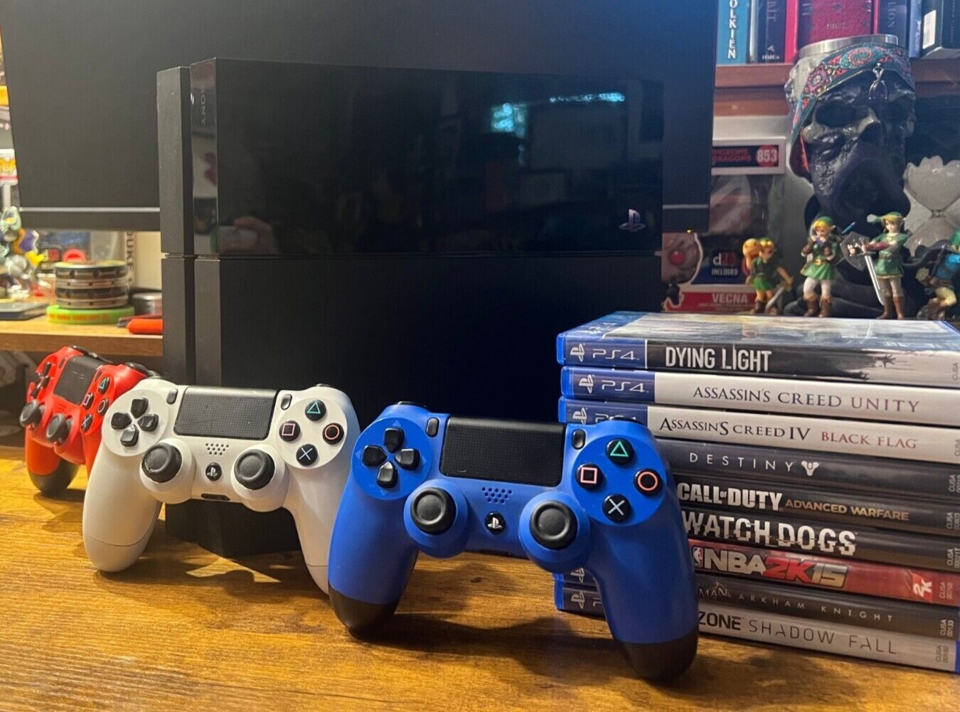 PlayStation 4 (Used) with 3 Controllers (red, white, and blue) and 9 PS4 Games