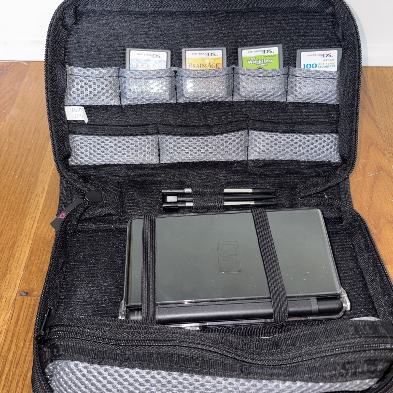 Nintendo DS Lite Console Black with charger case and four games model USG-001