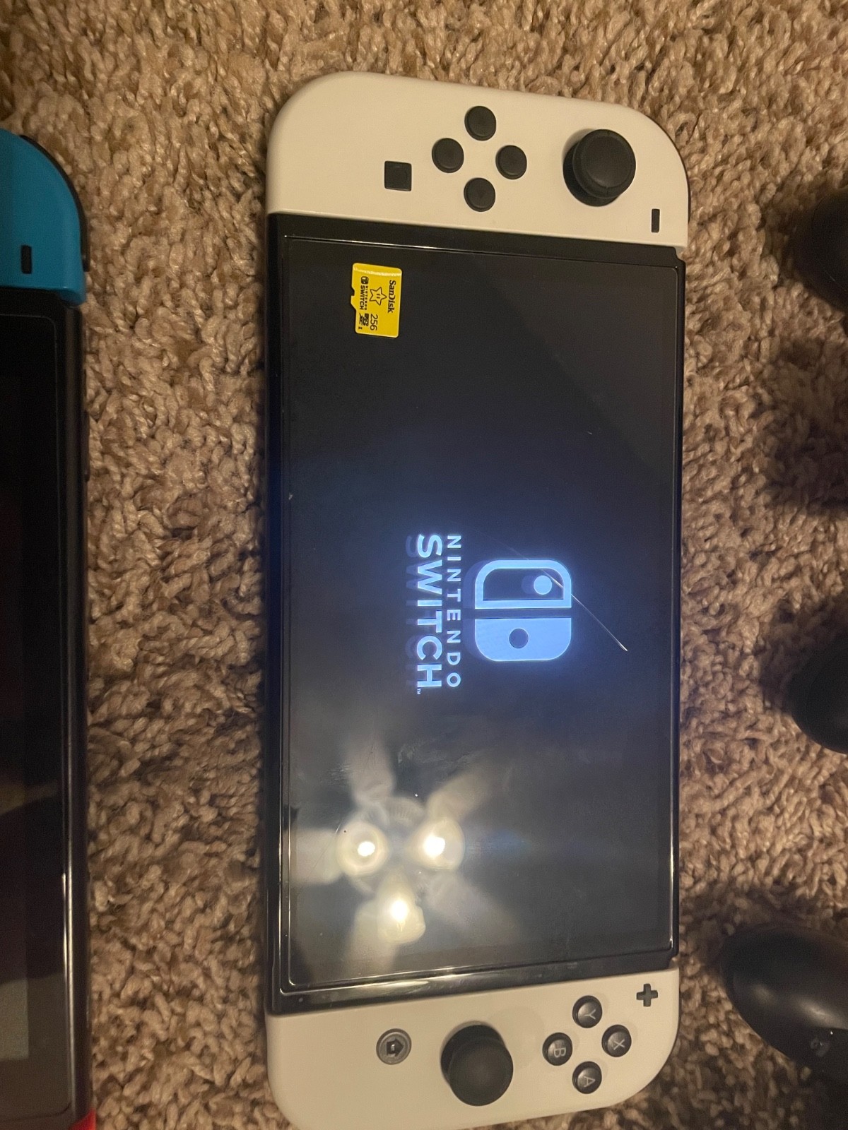 Nintendo Switch OLED console and regular Nintendo switch with accessories&games