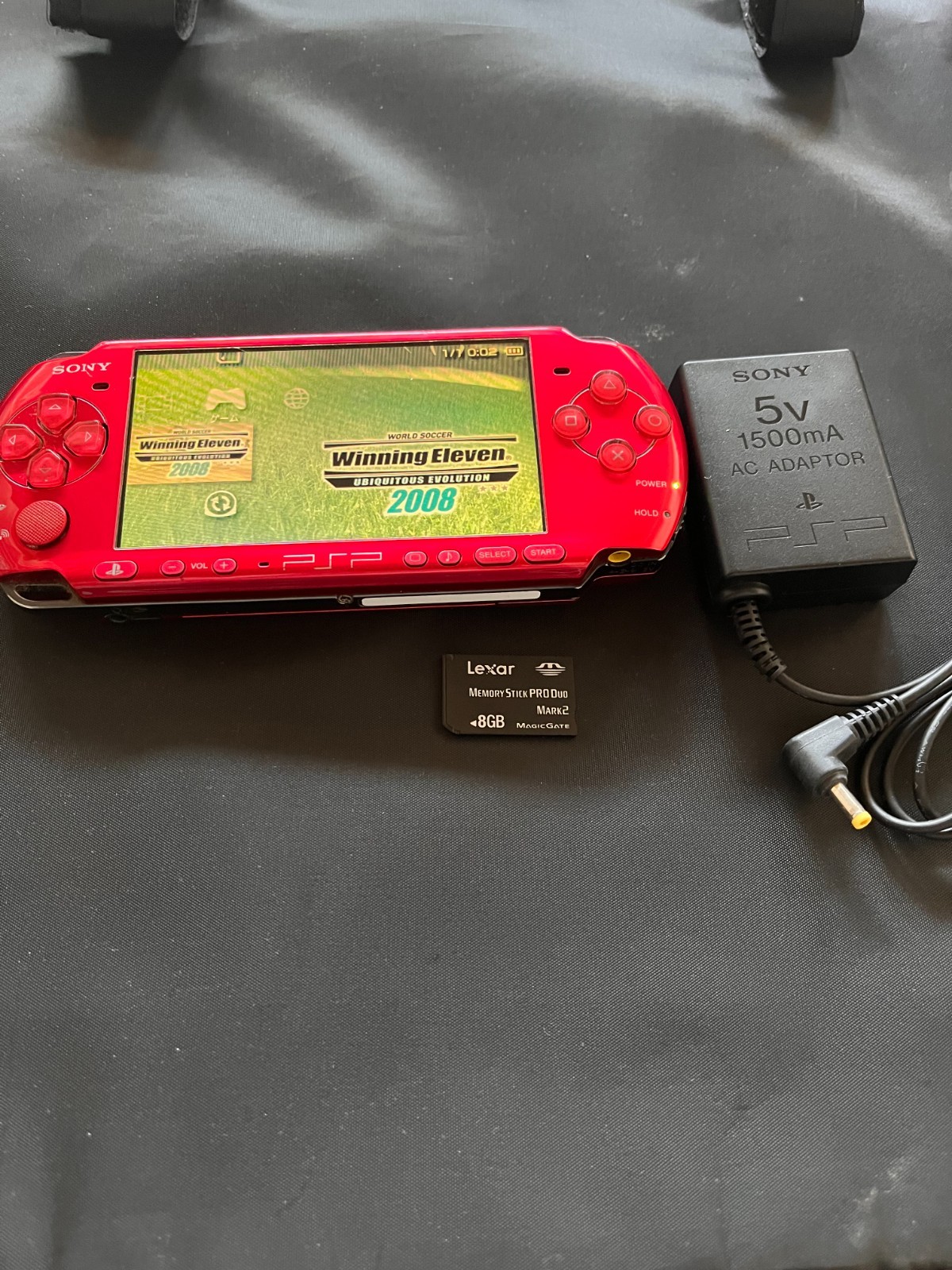 SONY PSP-3000 Radiant Red + AC charger + 8GB Memory – Working, Rank B