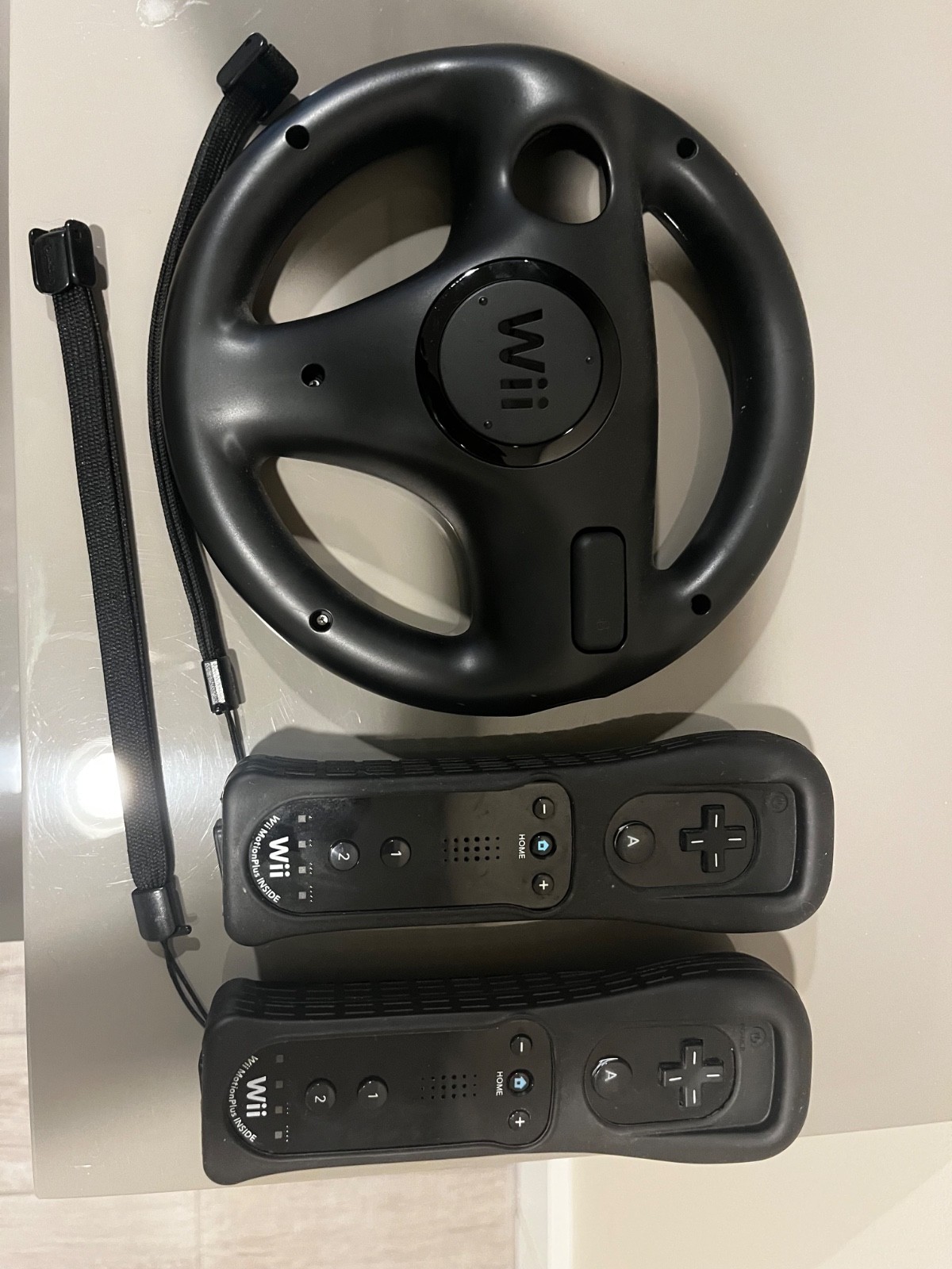 Nintendo Wii mini console (used), 2 controllers, and Nintendo Mario Kart Wheel