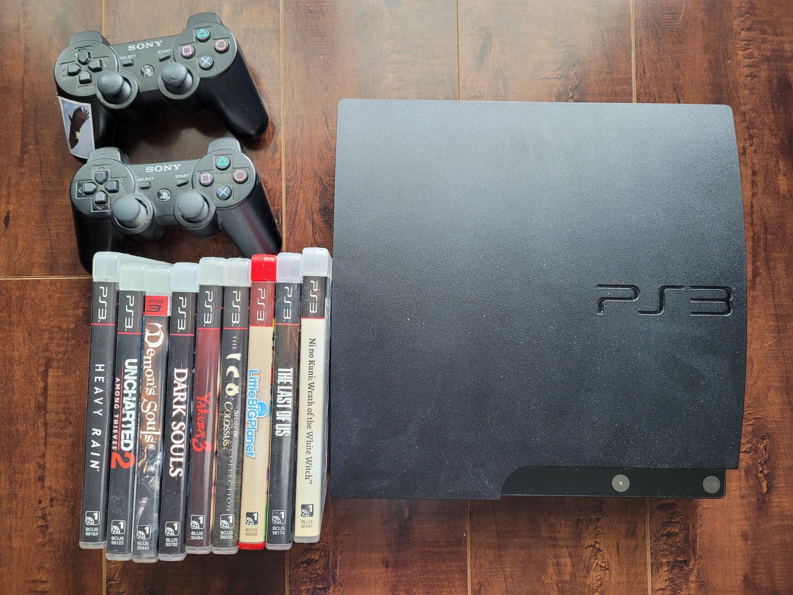 Sony PlayStation 3 Slim 120GB Console – Black, 2 controllers and 9 games
