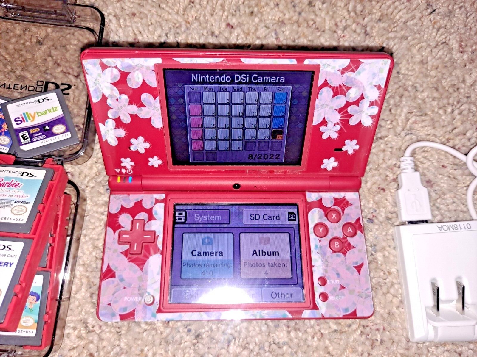 Nintendo DSi Red console system w 18 games in storage case w/ charger
