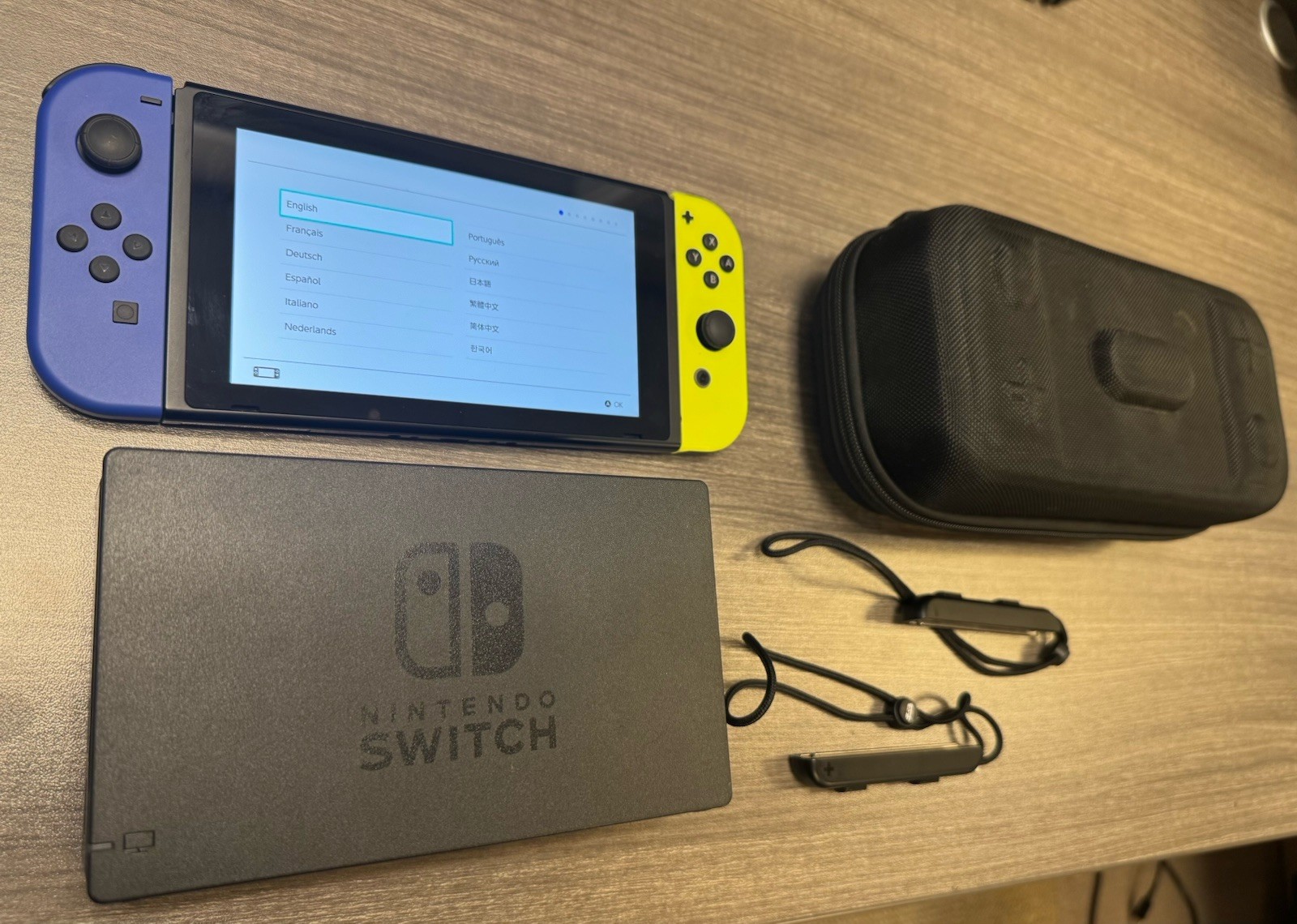 Nintendo Switch console with blue and yellow joycons and case