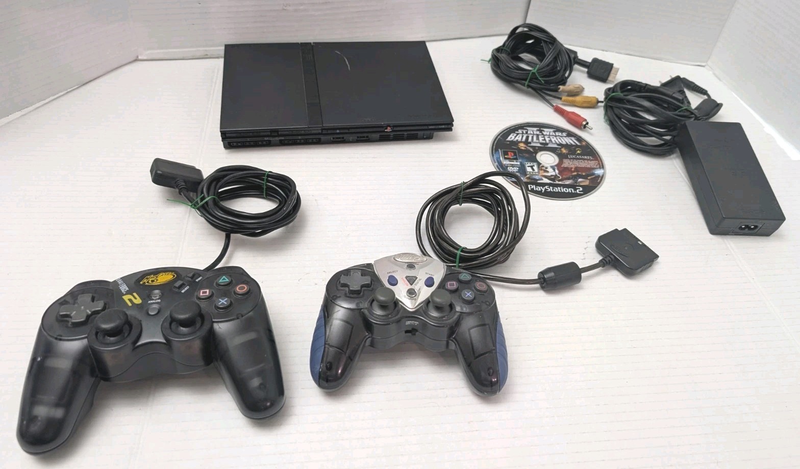 Sony PlayStation 2 Slim Black (SCPH-70012) With 2 Controllers, Game & Cords