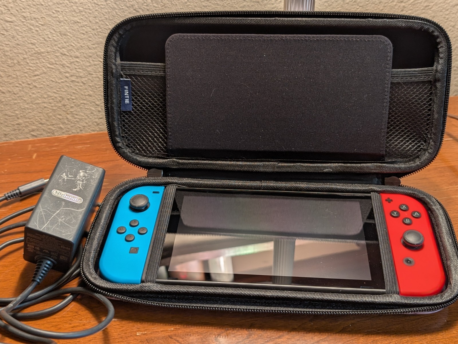 Gently used: Nintendo Switch, neon red/blue joy cons, power brick, carrying case