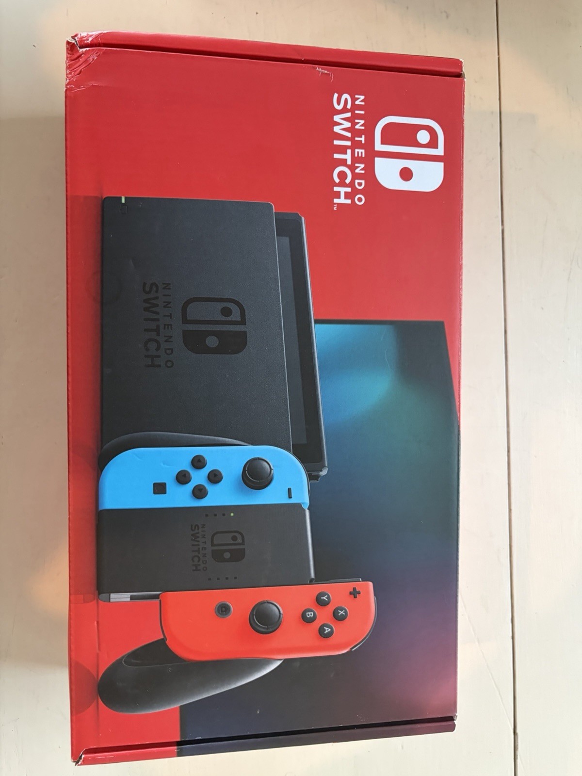 Nintendo Switch version 2, opened box, HAC-001(-01) handheld console, red/blue.