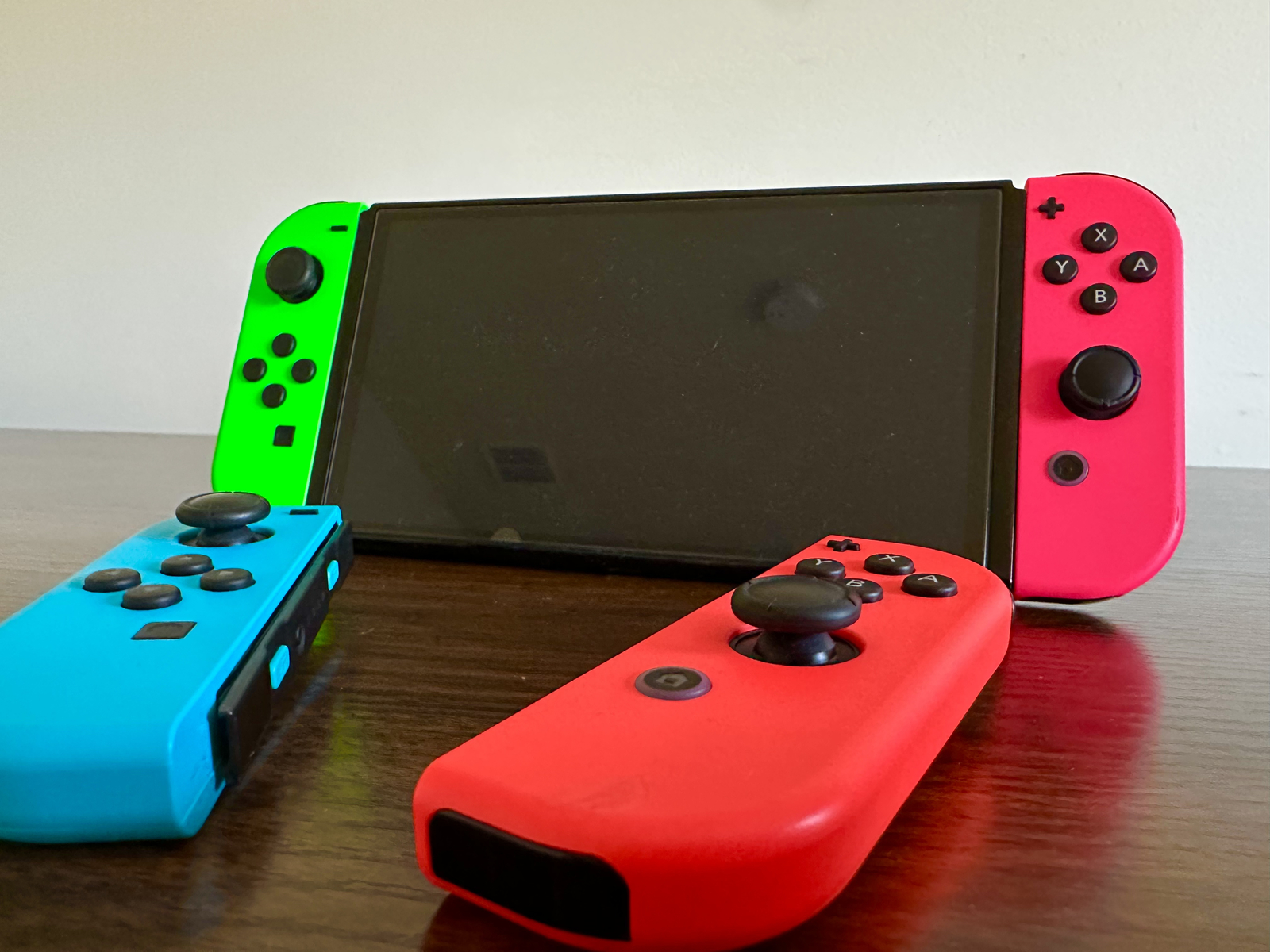 Nintendo Switch OLED – 64GB – Red/Blue with Green/Pink Joycons, Mario Game, Case