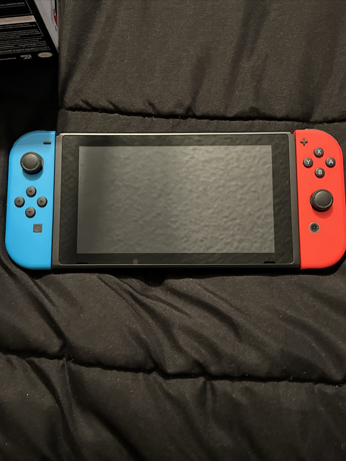 Nintendo Switch Blue and Red Joy-Con Controllers and Mario Kart 8