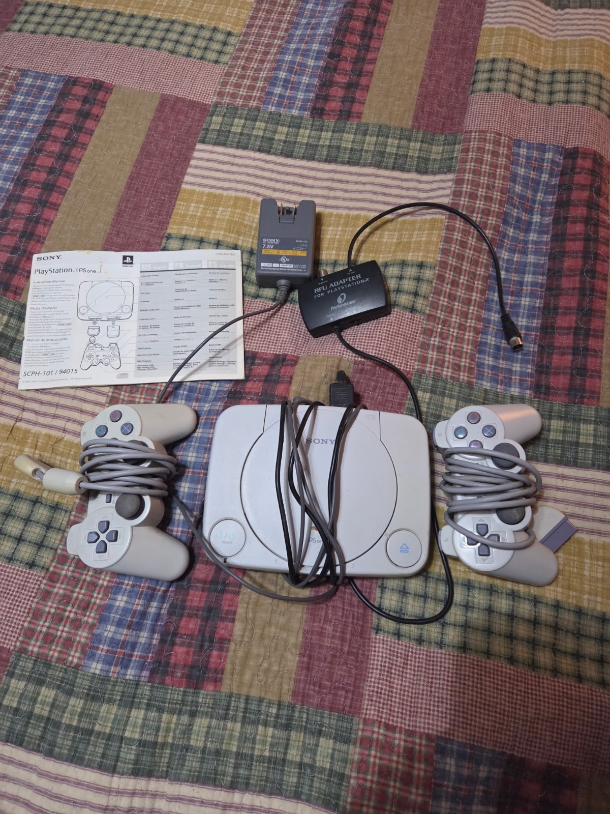 PlayStation 1 with various games tested in working condition has 2 controllers