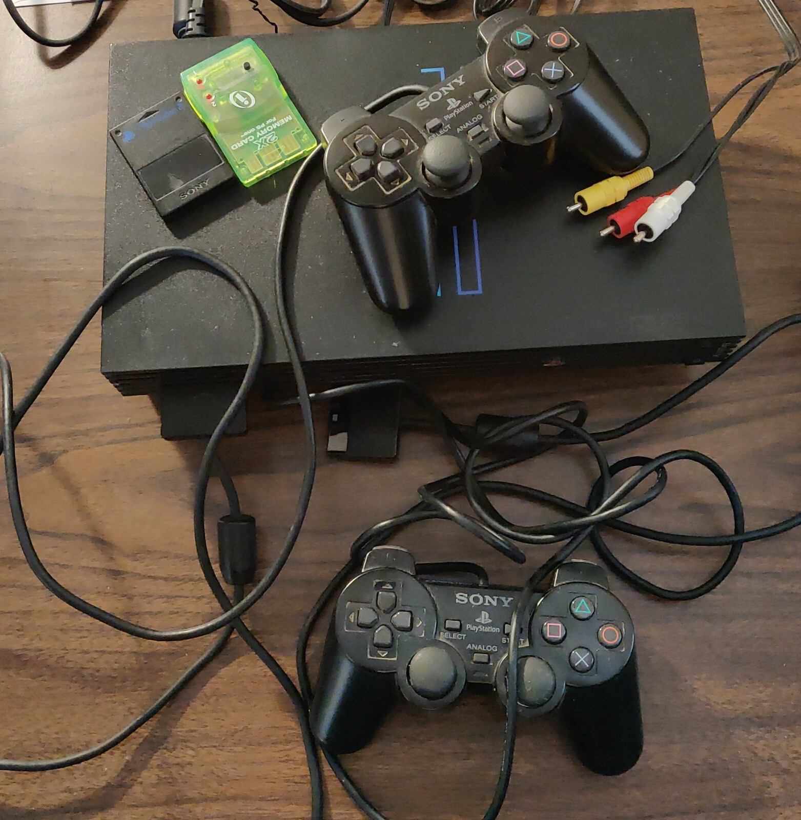 Sony PlayStation 2 Console with controller, memory cards, cables, and 12+ games
