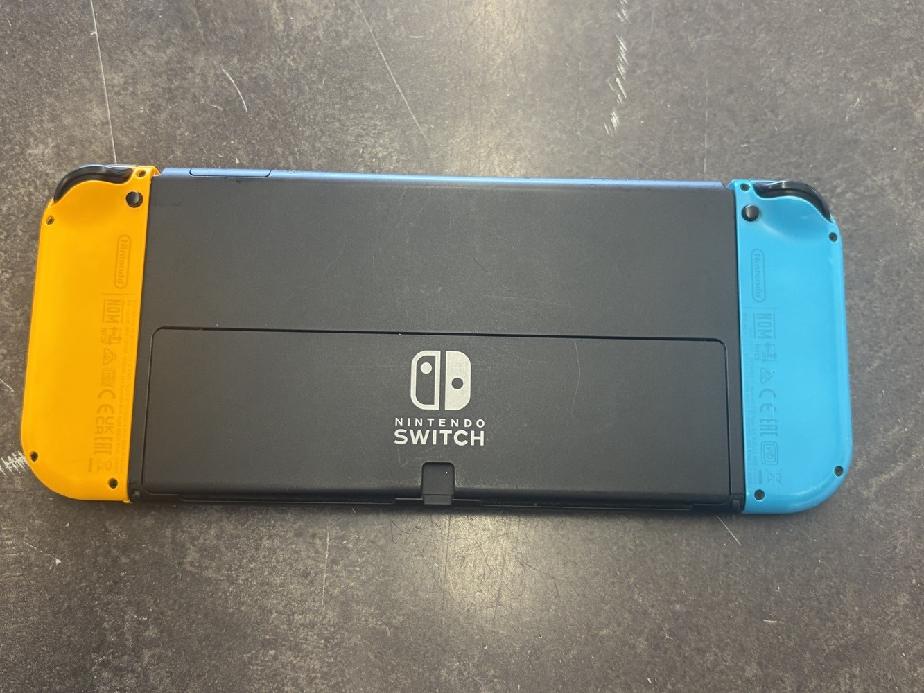 NINTENDO SWITCH OLED MODEL W/ NEON BLUE & NEON ORANGE JOY CONS