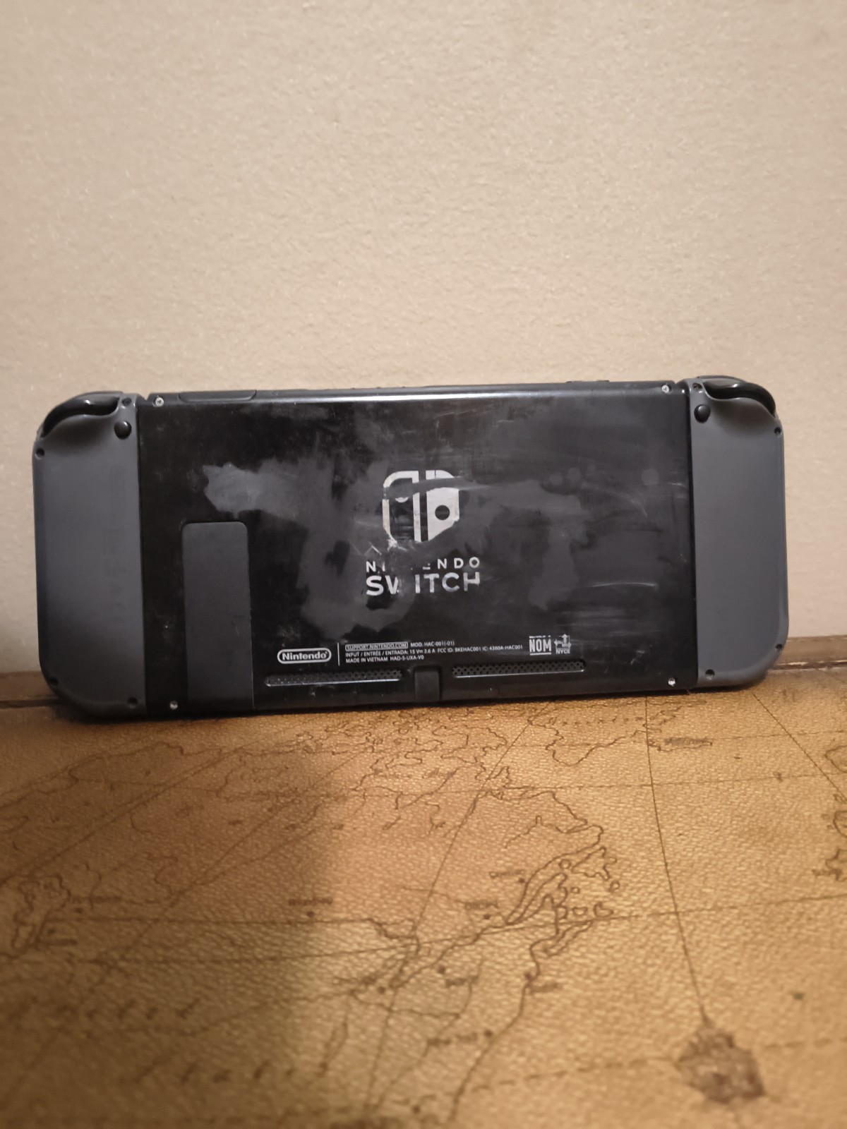 Nintendo Switch with joycon controllers, a charger, and a game case.