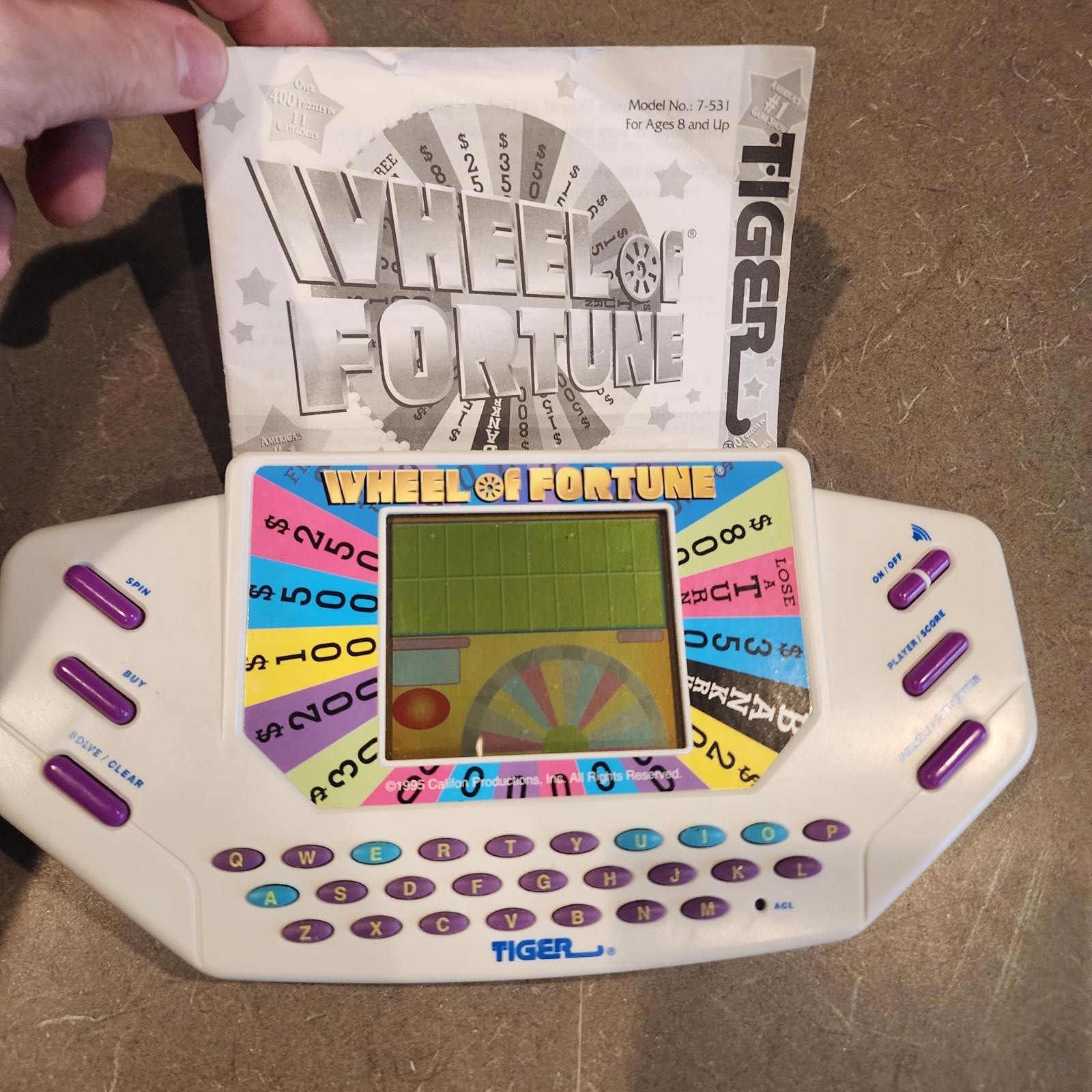 Wheel of Fortune Handheld Electronic Game works perfect EUC condition booklet